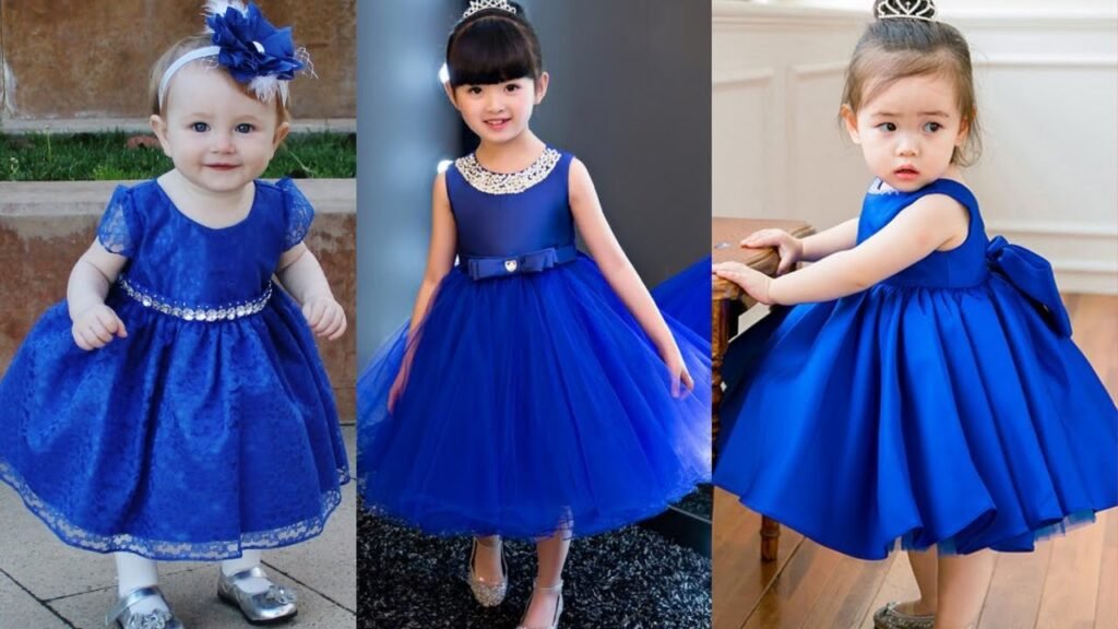 Little girl wearing a stylish baby blue frock with ruffle sleeves and matching hair accessories.
